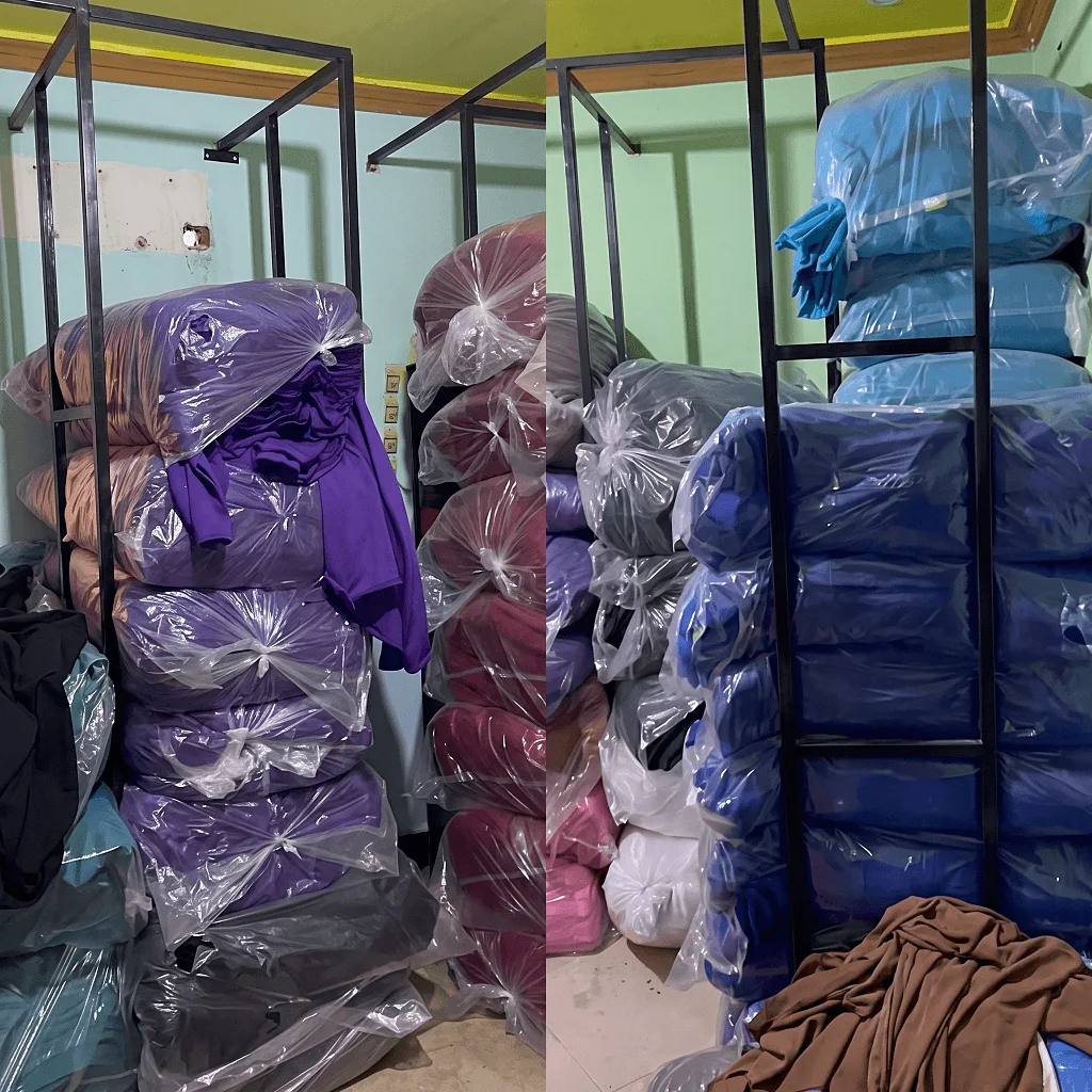 The fabric store: knit fabric in purple, blush, navy, blue and brown, bagged in clear polythene and stacked on steel racking.