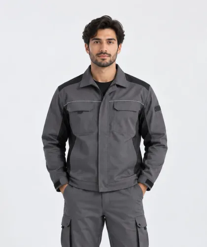 A man in a grey and black workwear jacket with matching cargo trousers.