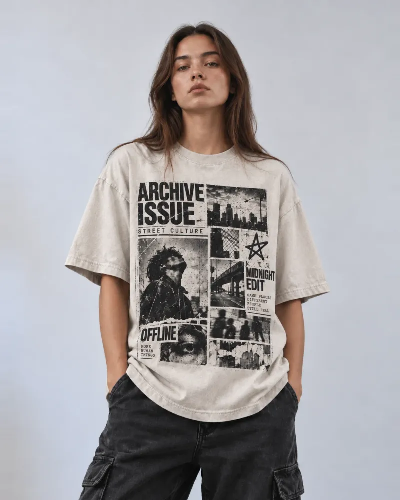 A model in an oversized stone-coloured heavyweight t-shirt printed with a black-and-white photo collage reading "Archive Issue", "Street Culture" and "Midnight Edit", worn with black cargo jeans against a pale studio backdrop.
