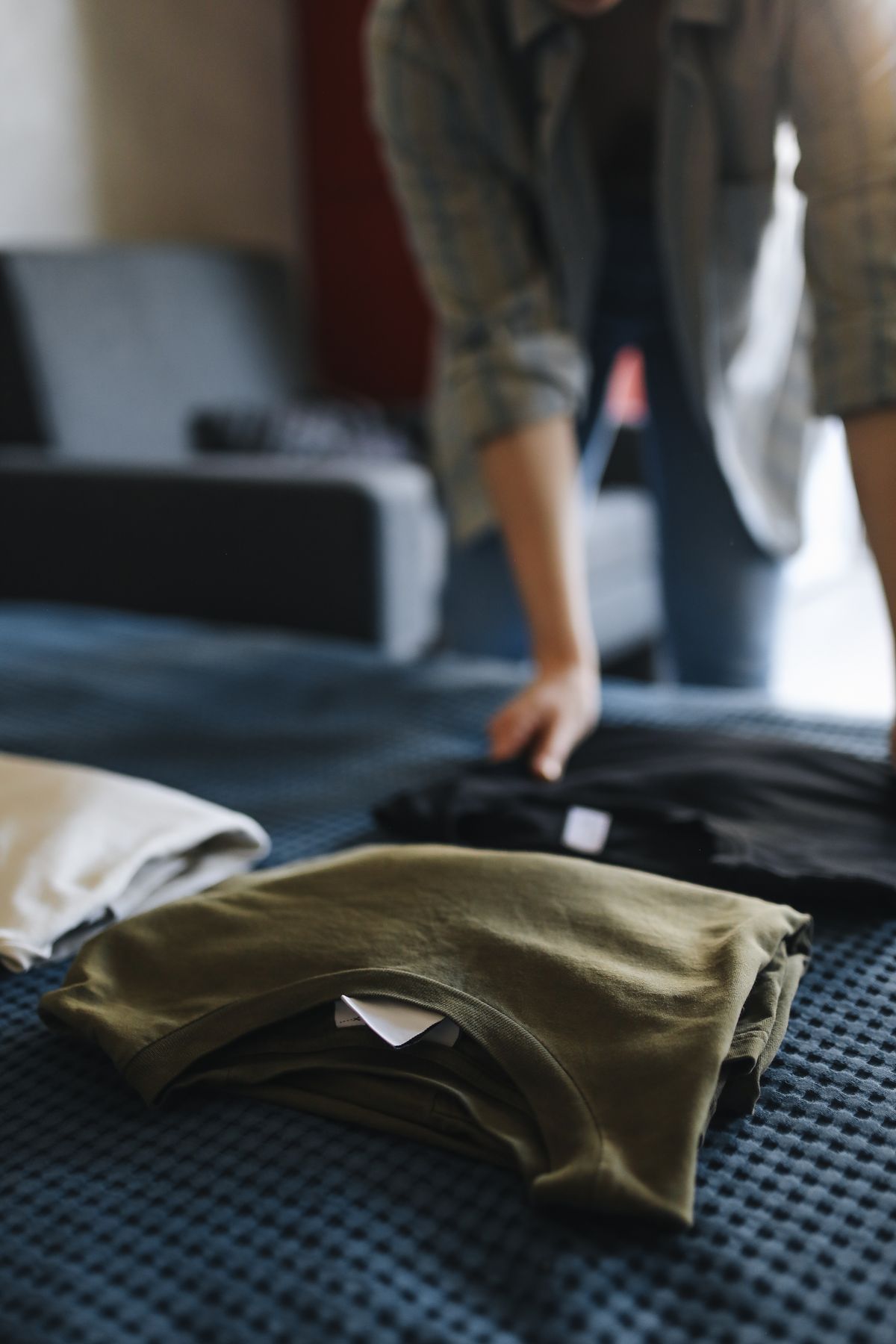 Heavyweight cotton t-shirts folded in a stack.